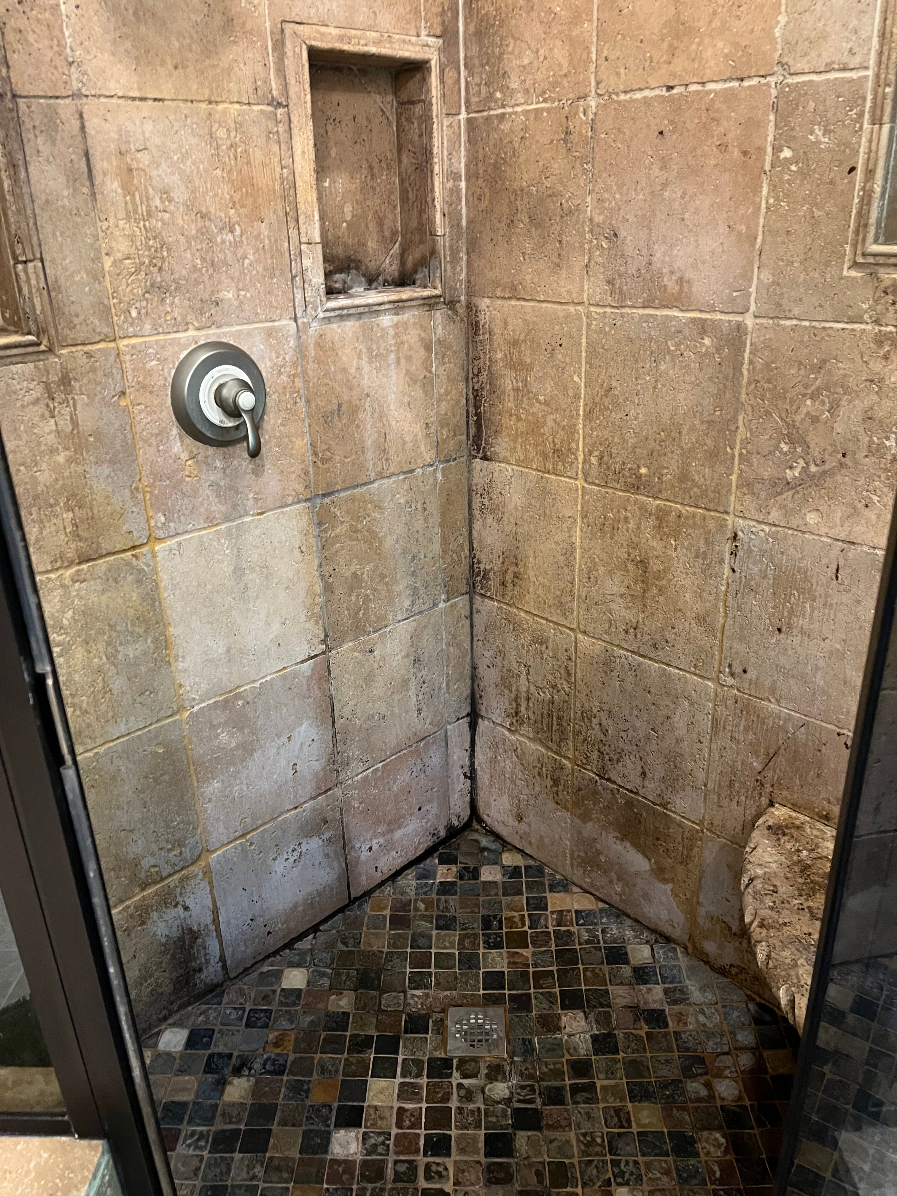 Dirty travertine shower